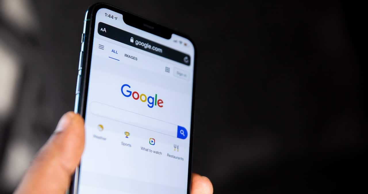 A person uses Google search on a mobile phone