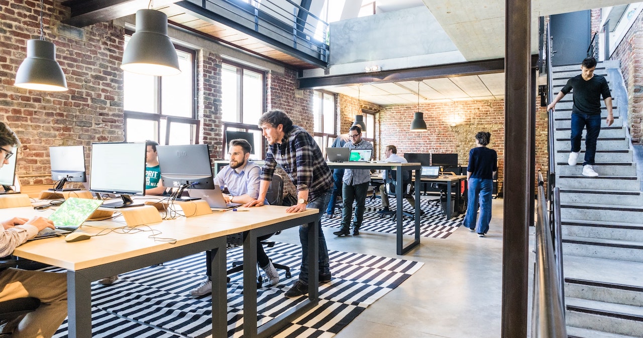 An open plan workplace with people using laptops