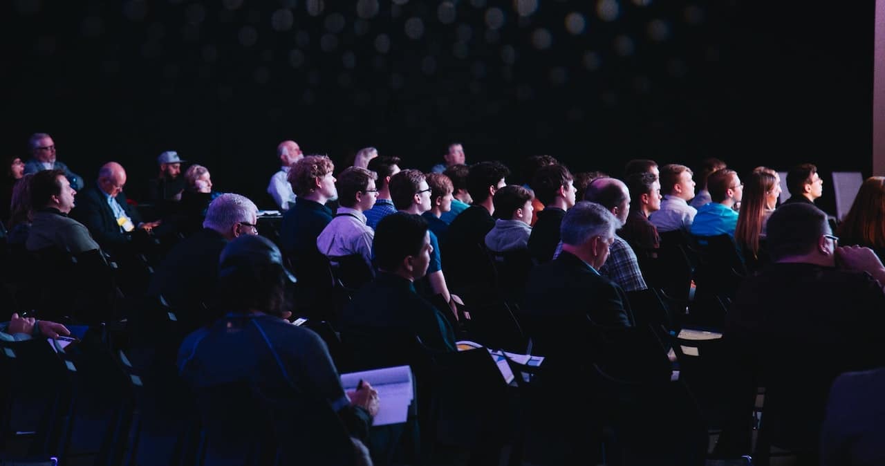 Attendees sat down in a dark room at a conference