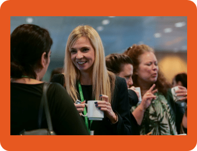 A group of people at an industry event standing around chatting