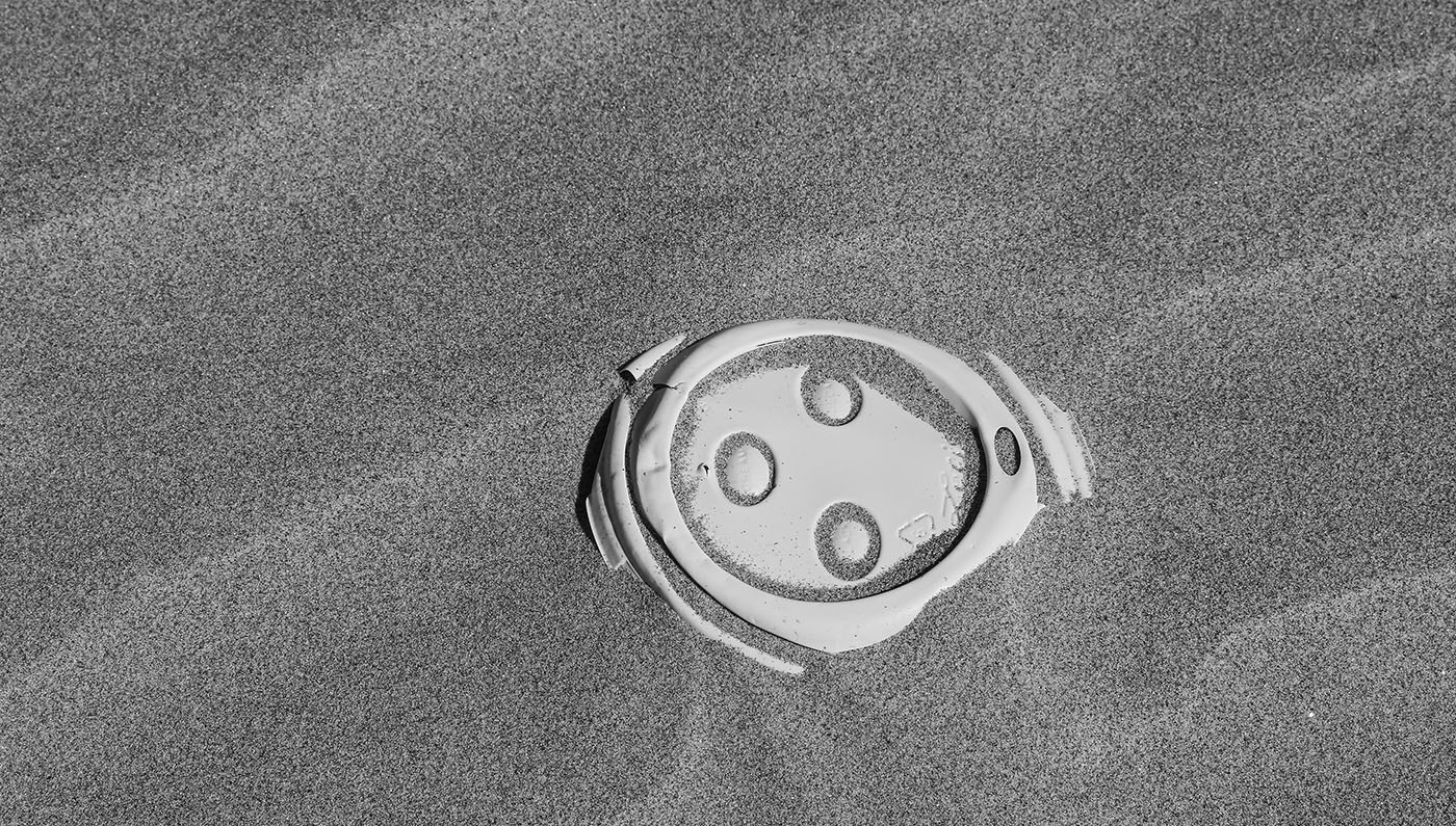 plastic lid in sand