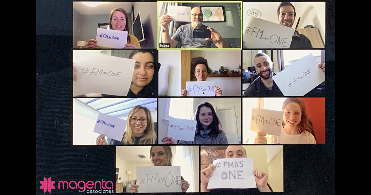 The Magenta Associates team hold up banners for the #FMasONE campaign this World FM Day