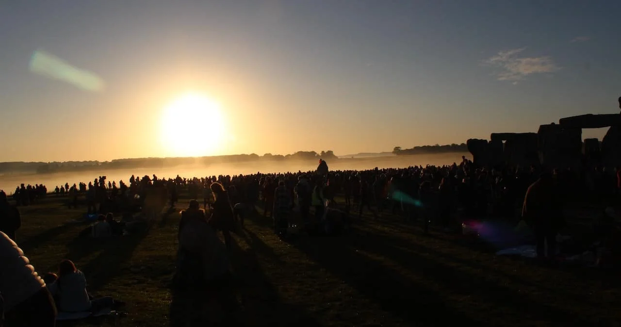 A sunset over a field of people