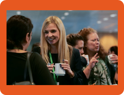 A group of people at an industry event standing around chatting