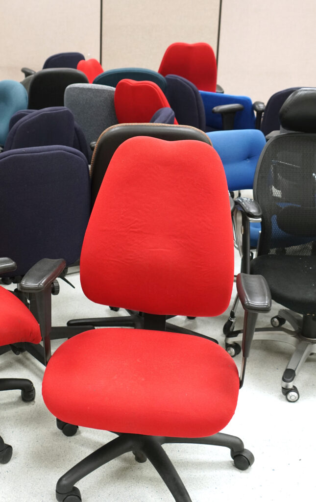 A vacant office room filled with desk chairs