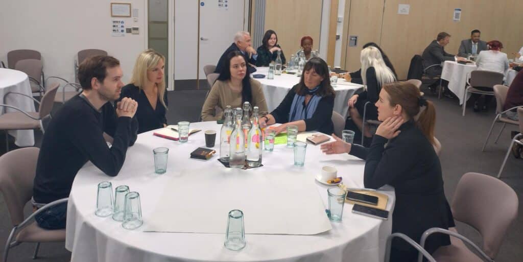Five people sit around a round table at the IWFM London Region conference
