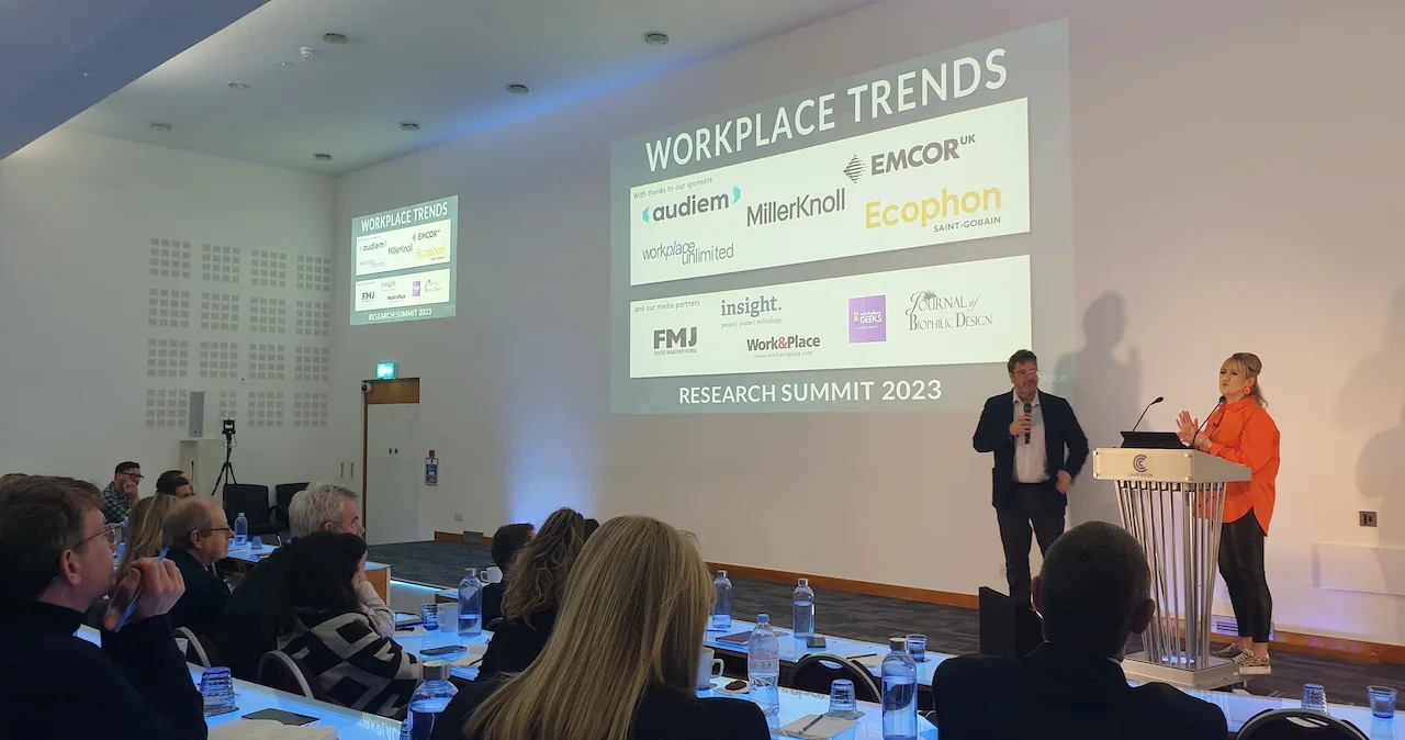 Two speakers on stage in front of an audience at the Workplace Trends Research Summit
