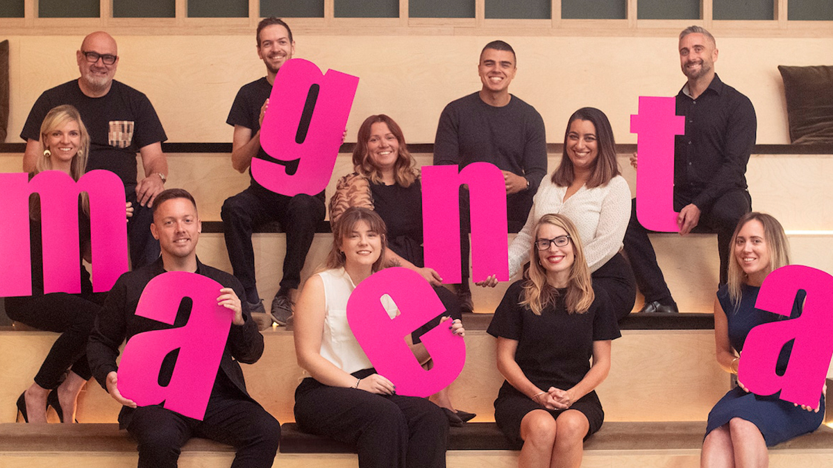 Magenta Associates - Team holding letters